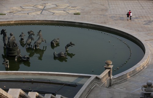 People walk past a fountain at the Tianducheng development in Hangzhou